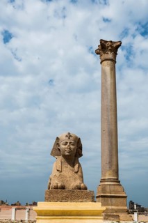 Roman archaeological site in the middle of the city and skyscrapers, Pompey's Column, Alexandria,