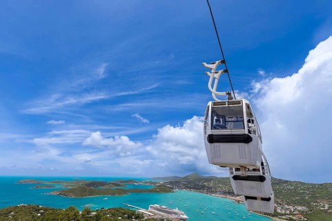 A cable car gondola rides above Charlotte Amalie harbor in St Thomas, US Virgin Islands, offering a