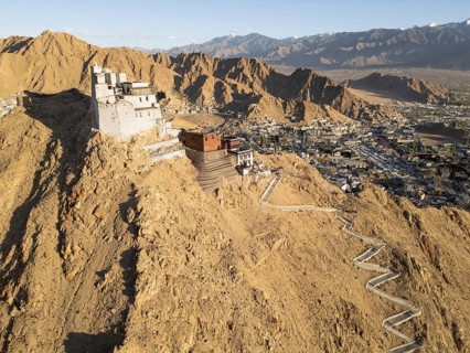 Aerial view showcasing the grandeur of Leh Palace in Ladakh, India. The ancient structure stands