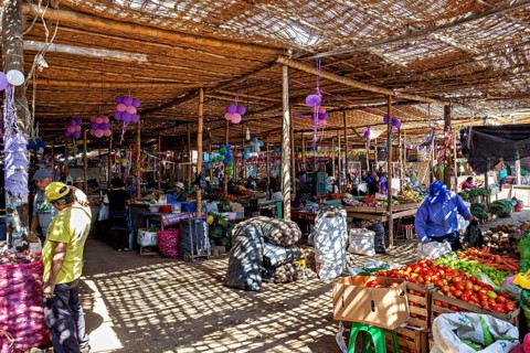 Indoor market with crowded stalls and colorful decoration, market and market stalls in the streets
