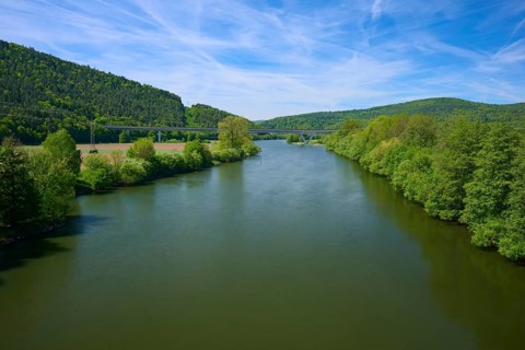 Peaceful river landscape between green hills and clear blue sky, Main, Gemünden am Main,