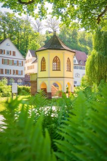 A pavilion surrounded by a historic building complex and green nature, Calw, Black Forest, Germany