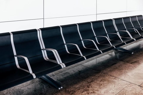 Empty black seats in waiting area at the airport