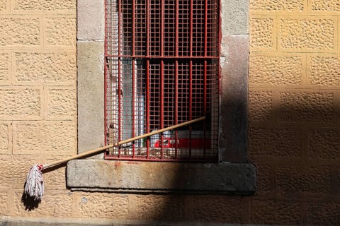A mop is chained to a window grille in Barcelona, Spain