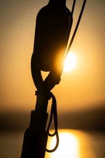 Part of the rigging of a sailing ship, anchoring, steel cable, back light, sunset, silhouette,