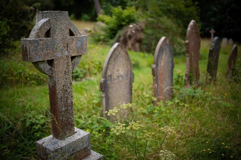Weathered graves, tombstones, Celtic grave cross, municipal cemetery, Falmouth, Cornwall, England,