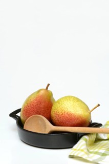 Pears in pot with cooking spoon, symbolic picture