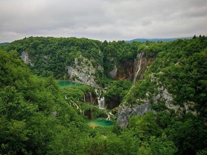 Panorama of majestic landscape with waterfalls and lush forest, Plitvice Lakes National Park,