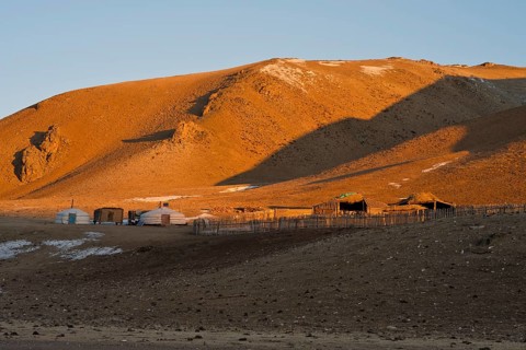 Yurt camp of Mongolian families with yurts, gers, and shelters for cattle, landscape in winter at