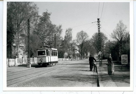 Nordhausen, Harz, Oberstadt, Old tram runs on a quiet city street surrounded by trees, GDR, May