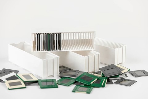 White and green slides are spread around white slide holders