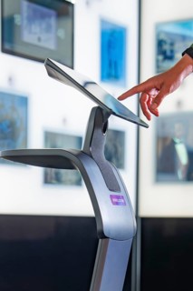 Hand operates a modern touchscreen in an exhibition, Robolutions museum robot, Marchivum, Mannheim,