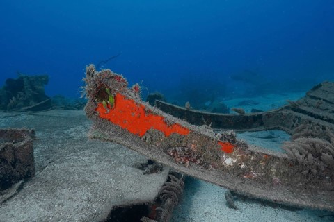 Shipwreck with rusty metal parts in blue underwater area, meteor wreck dive site, Russian