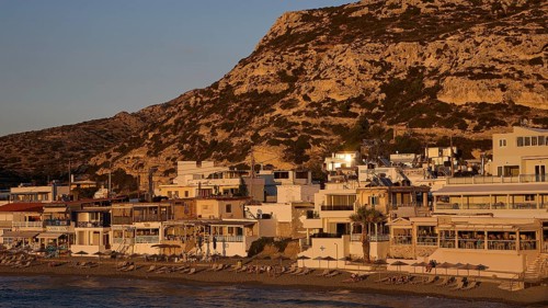 Coastline with houses in front of a hill at sunset, quiet atmosphere, Matala, south coast, Crete,