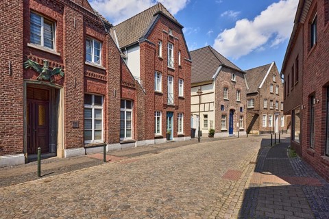 Historic city center, historic brick building Schwarzer Adler, building, façade with windows and