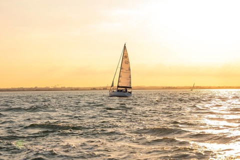 Sailing boat on calm water at sunset, peaceful atmosphere, Howth, Ireland