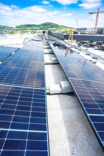 Long rows of solar panels on a roof under a clear blue sky, PV Assembly, Perrot, Calw, Germany