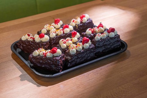 A tray of decorative chocolate chips with cream and cherries, Café Kuh, Deckenpfronn, Germany