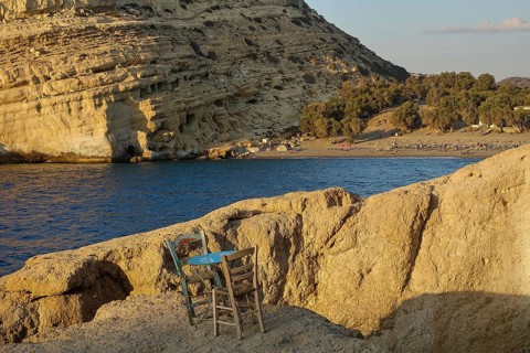 Neolithic caves, former hippie paradise, empty chairs on a rock by the sea, peaceful and natural