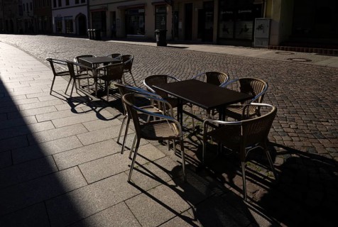 Tables and chairs of a restaurant or bar, empty, backlit, cobblestones, Luther city Wittenberg,