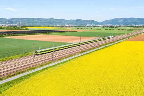 Aerial view of Flixtrain long-distance railway train on the Mannheim—Heidelberg railway line in