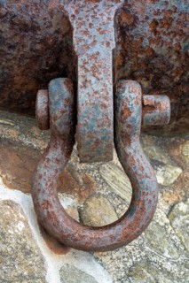 Rusted metal fastener, old shackle bolt, metal shackle with severe corrosion and outdoor surface