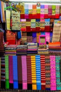 Colourful cloths lined up in a fabric shop, Kad Luang Warorod Market, Chiang Mai Thailand