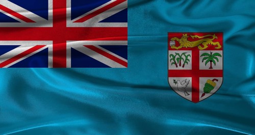 Flag of Fiji with fabric textured background. Close up of National flag of Fiji with realistic
