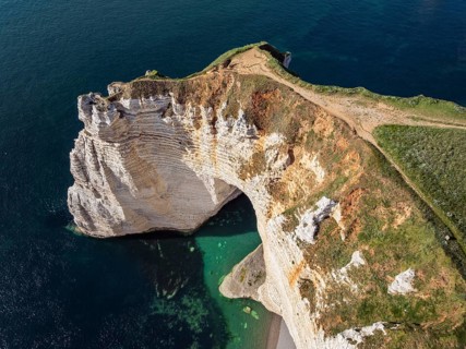 Aerial view, top down view of the rock formation with viewpoint and the La Manneporte rock gate in