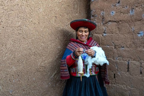 Friendly smiling woman, Valentina in traditional clothes of the Quechua indigenous ethnic group