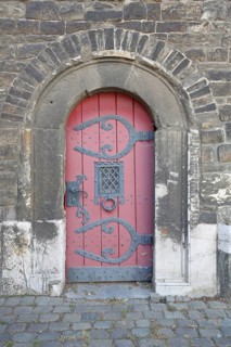 Semicircular red wooden door with fittings built at Ponttor 14th century, city tower, city gate,