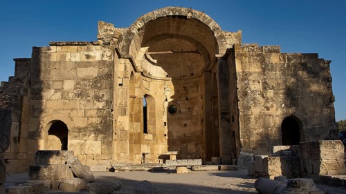 Titus Basilica, Greece, ancient ruin with large arch, illuminated by the sun, Gortyn, Gortyna,