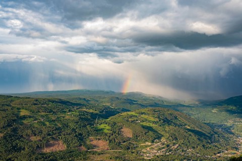 Rainbow and rain shower over Gol, Hallingdal, Buskerud, Norway