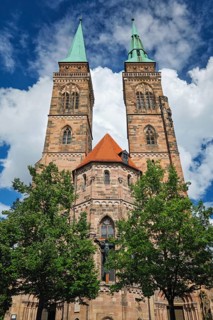 Front view of St Sebaldus Church in Nuremberg, Germany, with twin church towers, red roof detail