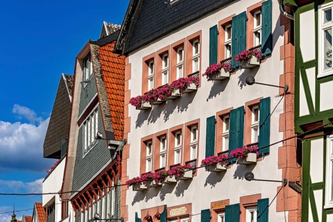 Half-timbered houses in an old town with flowers on the windows and a clear blue sky, historic
