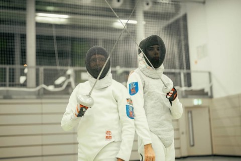 Two fencers pose with swords raised and full equipment in a sports arena, fencing, TSV Calw, Calw