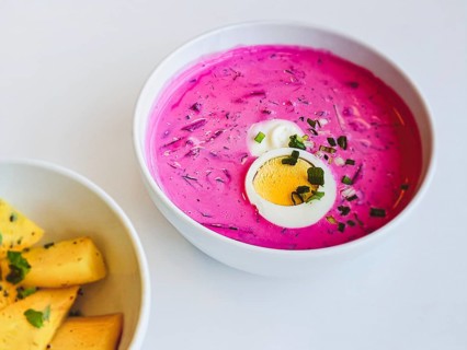A bowl of popular Lithuanian cold beetroot soup Saltibarsciai or cold borscht with baked potato