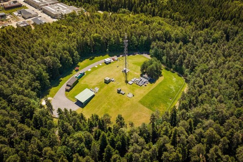 Aerial view of a radio tower and surrounding buildings in a dense forest area, Bunker Anlage, Calw,