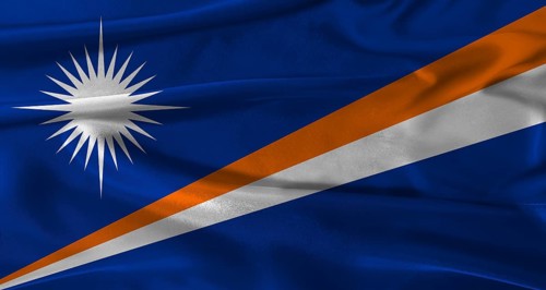 Flag of Marshall Islands with fabric textured background. Close up of National flag of Marshall