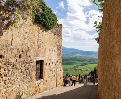 Tourists traveling in the small town of Pienza in Tuscany, Italy