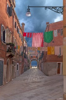 Colourful laundry stretched on linen between houses, Castello district, Venice, Veneto, Italy