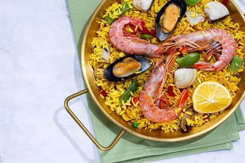 Seafood paella, shrimp and mussel risotto, rice, paella in a pan, homemade, natural light, top