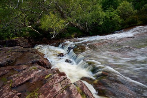 Small waterfall over rocks surrounded by thick vegetation, Victoria Falls, Slattadale, Achnasheen,
