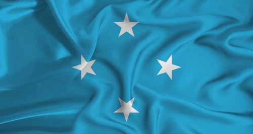 Realistic Micronesia flag waving. Close up of flag of Micronesia with cloth texture