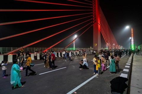 People gather on the newly inaugurated Kumar Bhaskar Varma Setu, a six-lane cable styled bridge