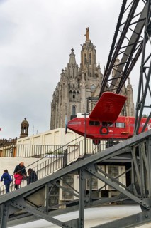 Red aeroplane, simulator, ride in front of church, Sagrat Cor, cloudy sky, Tibidabo amusement park,