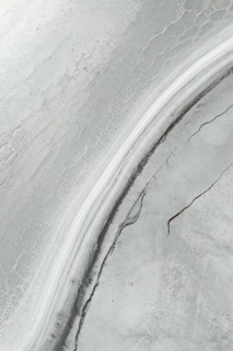 Aerial view of a saline mud landscape showcasing intricate patterns and textures. The unique
