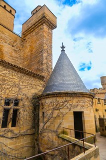 Majestic royal palace of olite in navarre, spain, featuring weathered stone walls, a conical roof