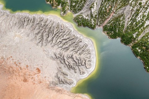 Lake with sandbank and dead trees, crater rim of chaiten volcano, aerial view, Patagonia, Chile