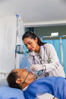 A compassionate doctor attentively assists a patient in a hospital room, ensuring proper care with